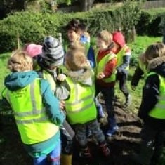 Children in the village orchard, planting seeds