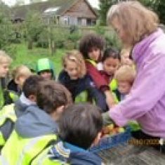 Children in the village orchard, listening to a talk