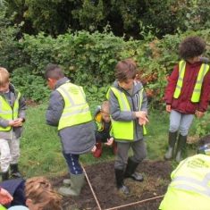Children in the village orchard, planting seeds